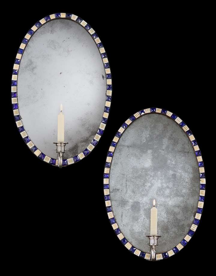 A PAIR OF IRISH GEORGE III OVAL MIRROR GIRANDOLES